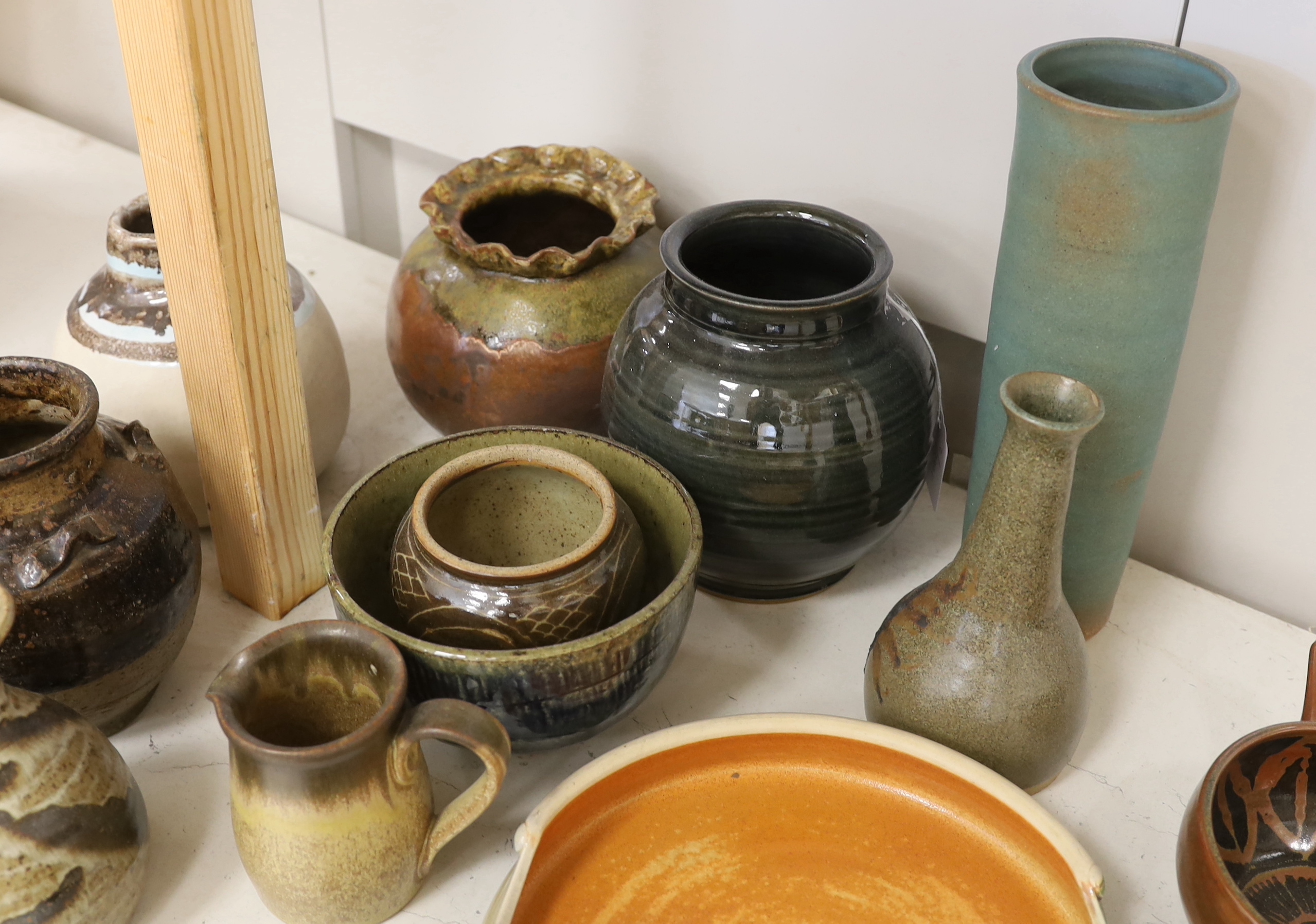 A large collection of mixed studio pottery vases, bowls and dishes